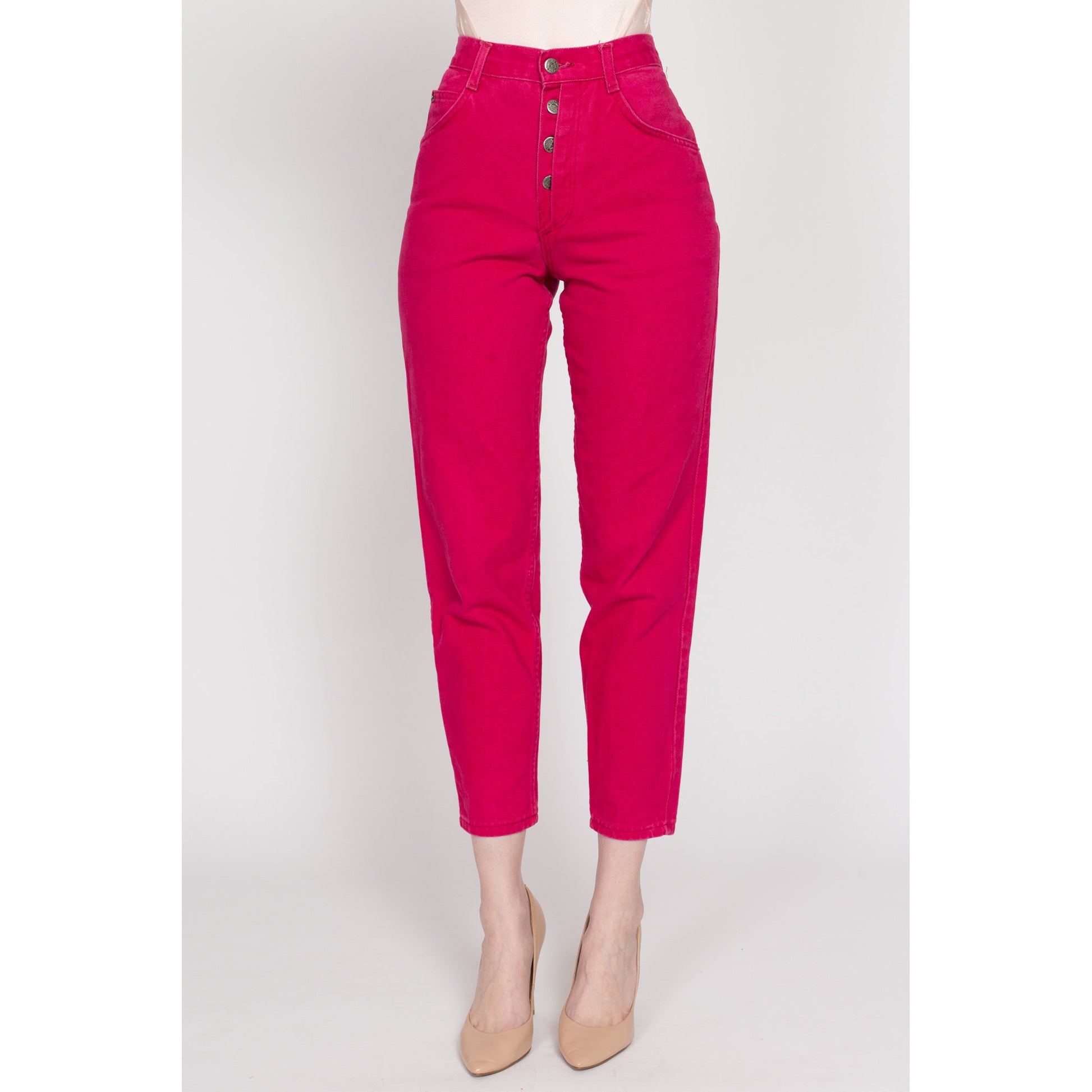 High-waisted pink jeans with visible buttons